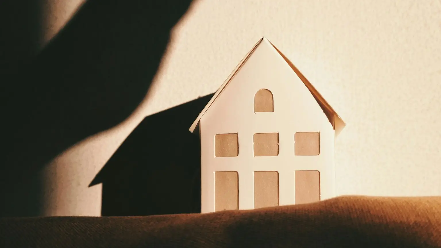 white and brown house on brown textile